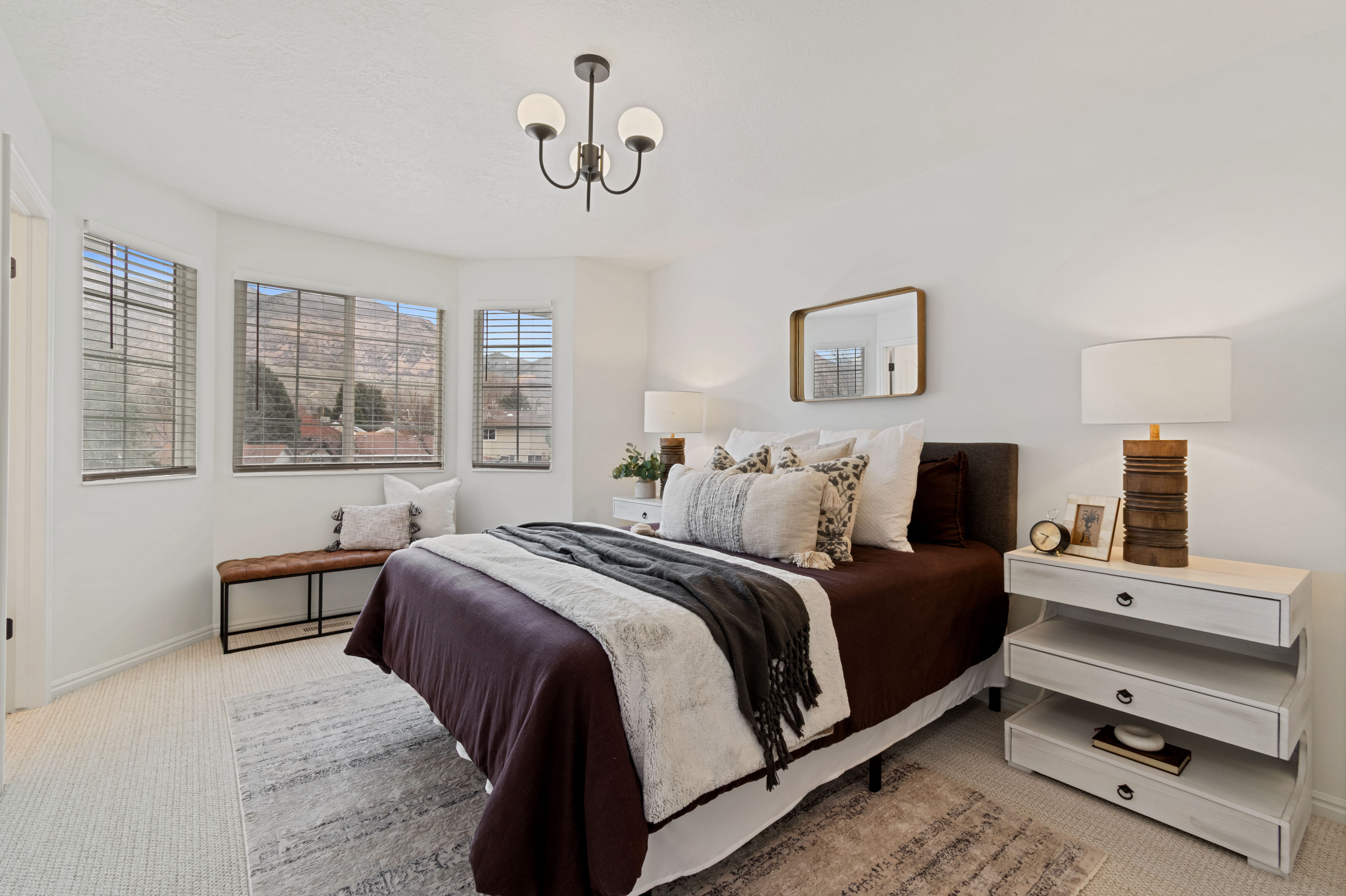 Bedroom featuring light colored carpet and hanging lights