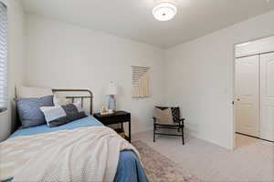 Carpeted bedroom featuring baseboards