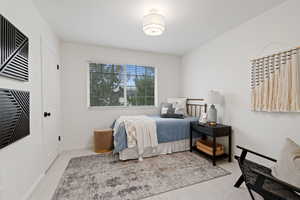 Bedroom with baseboards and light colored carpet