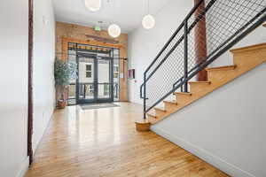 Building lobby featuring a high ceiling and brick wall