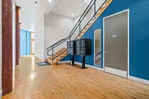 Foyer with light wood finished floors and recessed lighting