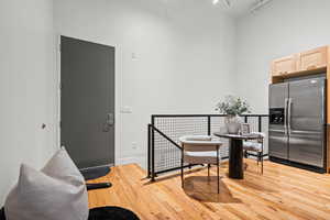 Dining room with a high ceiling and light wood-style floors