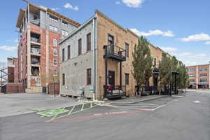 View of building exterior with uncovered parking