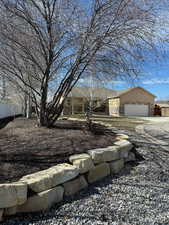 View of front of house with an attached garage and driveway