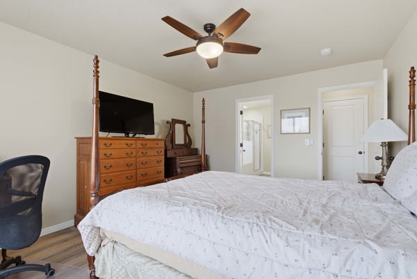 Bedroom with LVP flooring and a ceiling fan
