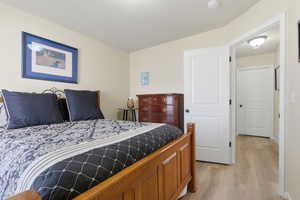Bedroom featuring light wood-style flooring and baseboards
