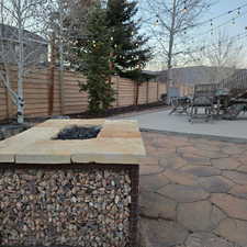 Fenced backyard featuring a patio and a fire pit