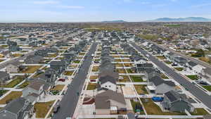Aerial view of property's location with nearby suburban area and a mountain backdrop