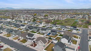 Aerial overview of property's location featuring a mountain backdrop and nearby suburban area