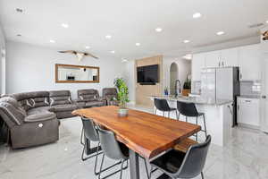 Dining room with arched walkways and recessed lighting