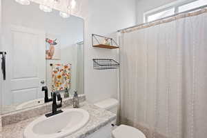 Bathroom with vanity and curtained shower