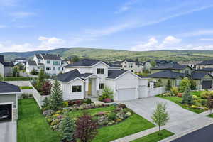 Modern farmhouse featuring a residential view, driveway, and board and batten siding