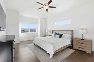 Bedroom featuring ceiling fan, dark wood-style flooring, and a mountain view