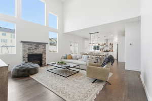 Living area with dark wood finished floors, a fireplace, and recessed lighting