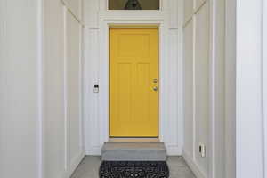 Property entrance featuring board and batten siding