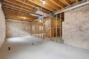 Unfinished basement featuring stairs