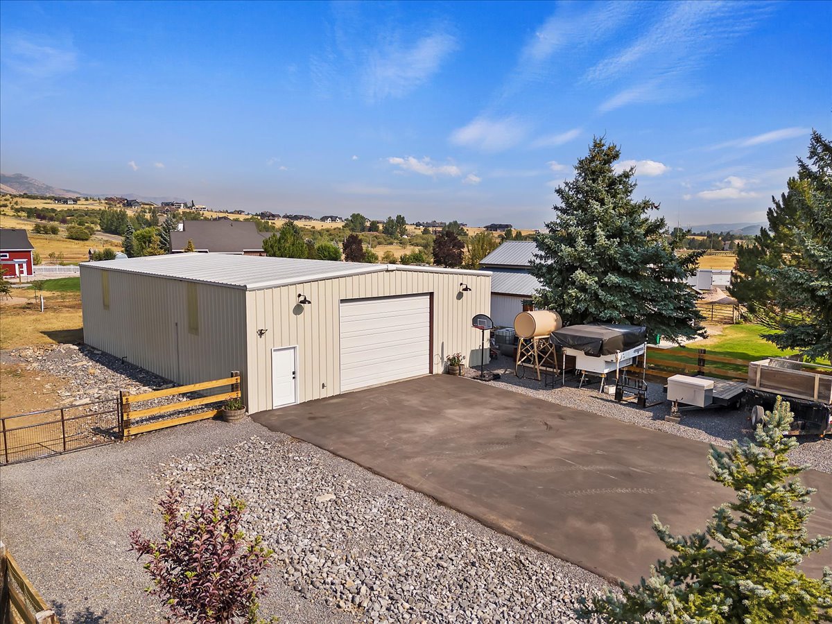 Detached garage featuring driveway and a gate