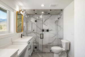 Full bath with vanity and a marble finish shower