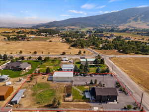 Aerial view of sparsely populated area with property boundaries highlighted and a mountainous background