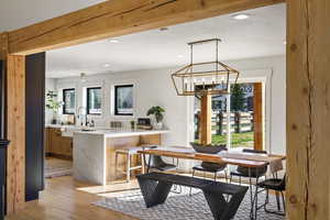 Dining area featuring a chandelier and light wood-style floors