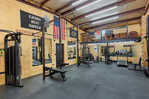Exercise room featuring a high ceiling