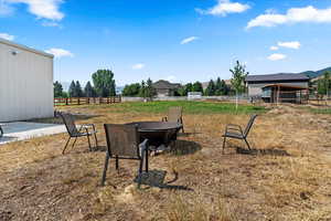 View of yard with a patio area, an outbuilding, and a mountain view