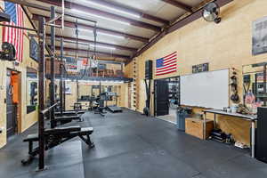 Exercise room featuring a high ceiling