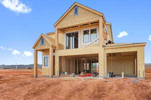 Rear view of property featuring a patio area and a mountain view