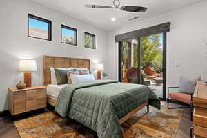 Bedroom with dark wood-type flooring, access to exterior, a ceiling fan, and recessed lighting