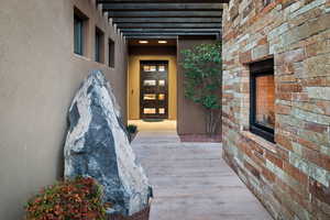 Doorway to property with stucco siding