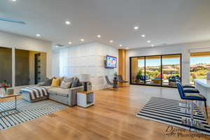 Living room featuring light wood-type flooring and recessed lighting