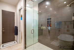 Full bath featuring a stall shower and tile patterned floors