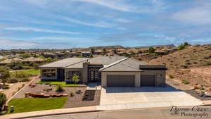 Prairie-style home with a garage, a residential view, concrete driveway, and french doors