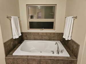 Full bathroom featuring a bath