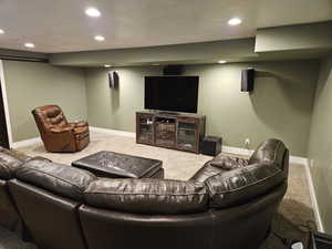 Living area featuring carpet floors and recessed lighting