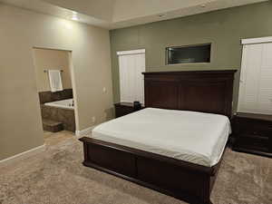 Bedroom with carpet flooring and ensuite bathroom