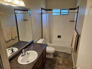 Bathroom featuring vanity and shower / bath combination with curtain