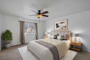 Bedroom featuring light carpet and a ceiling fan