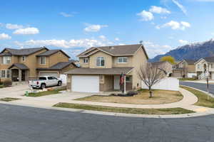 Traditional-style home featuring a residential view, concrete driveway, a porch, stucco siding, and an attached garage