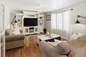 Living area with wood finished floors and baseboards
