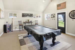Playroom with vaulted ceiling, light carpet, and billiards
