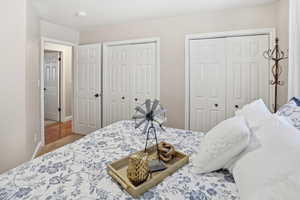 Bedroom featuring two closets and baseboards