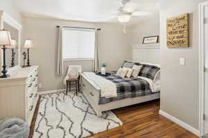 Bedroom with dark wood-style floors and a ceiling fan