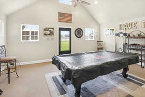 Recreation room with light carpet, a high ceiling, billiards table, and ceiling fan