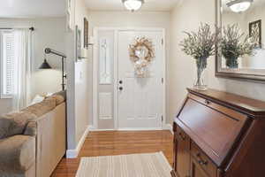 Foyer with light wood-style flooring and baseboards