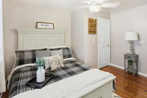 Bedroom featuring dark wood-style flooring and a ceiling fan