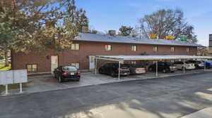 View of building exterior featuring covered parking