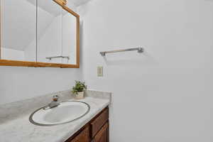 Bathroom featuring vanity and a textured ceiling