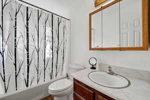 Bathroom with vanity and shower / tub combo