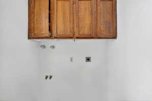 Laundry area with cabinet space, washer hookup, and electric dryer hookup